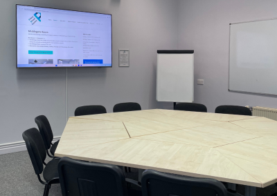 Boardroom set up with media screen