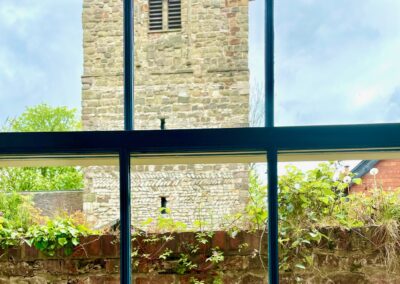 Looking out the of window to a historical building tower