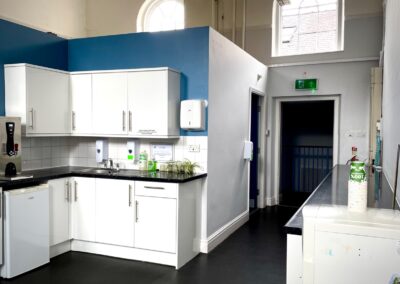 Kitchen area with sink and worktop space
