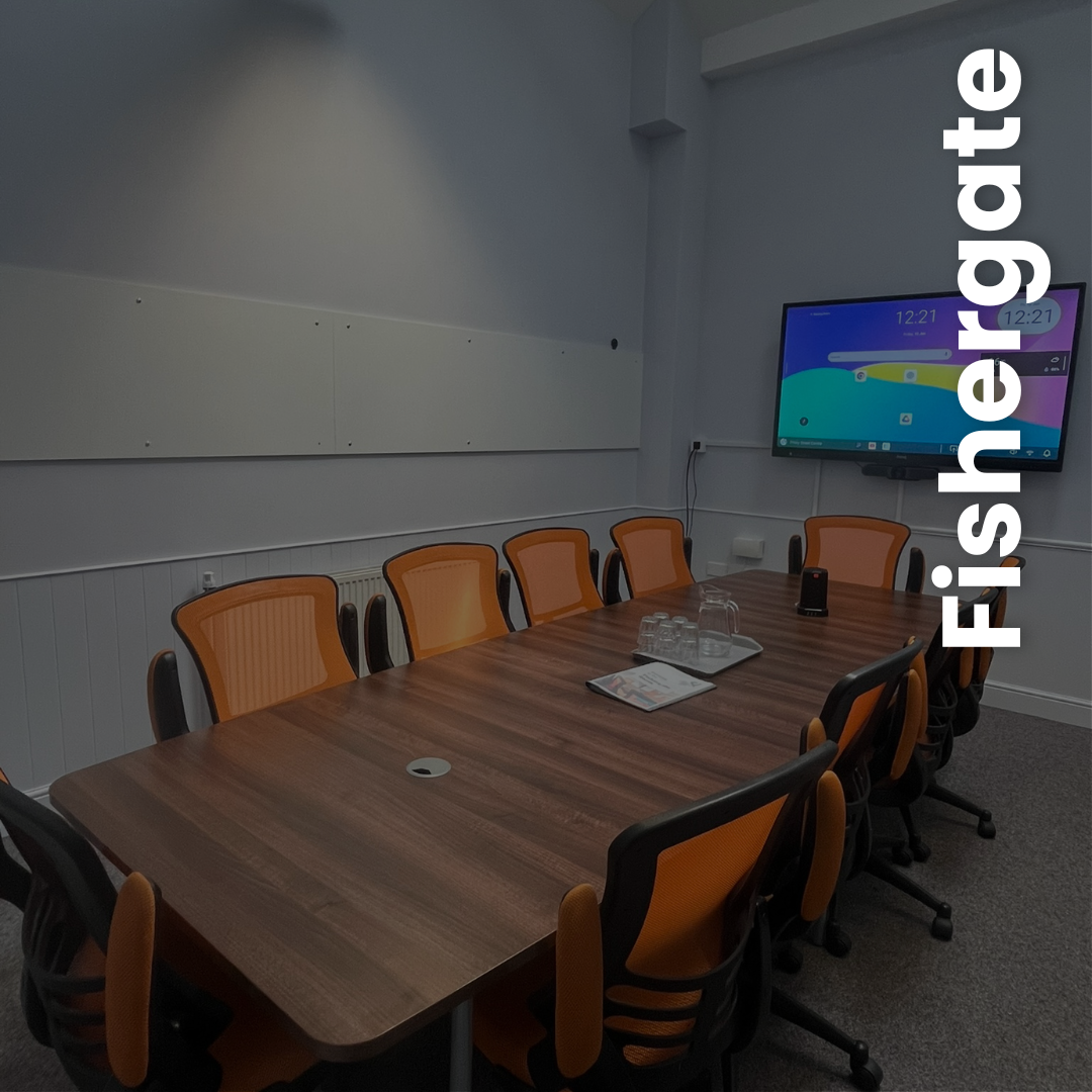 Fishergate Room Image of a medium sized table with 10 executive chairs and a multi-media screen
